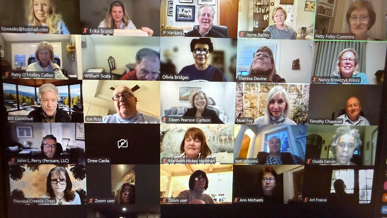 A Zoom video call with twenty participants in a grid layout. Most people are smiling and appear to be in home or office settings. Some names are visible on the screen.